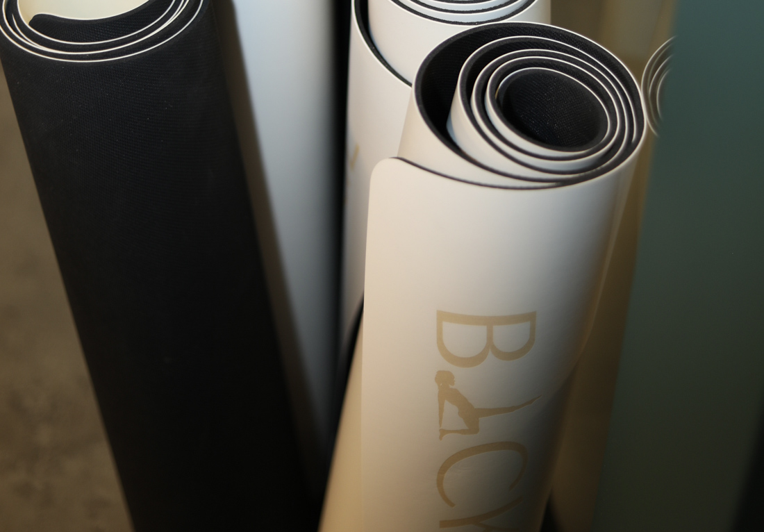 Group mat Pilates posture work with yoga blocks