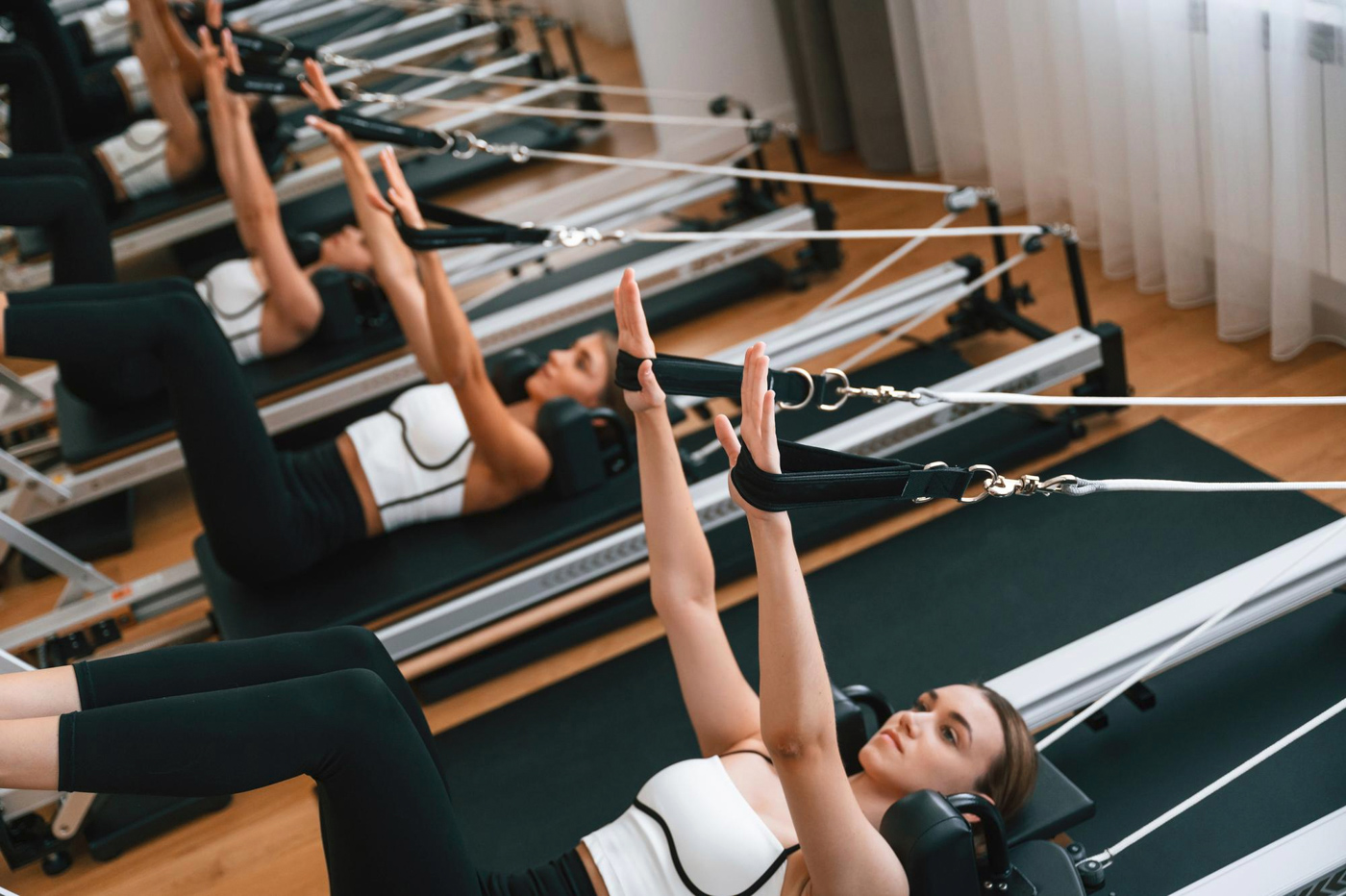Pilates reformer group class with straps