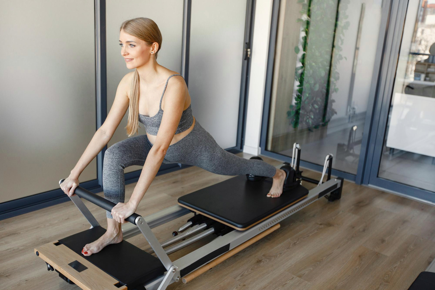 Pilates reformer exercise in bright Miami studio